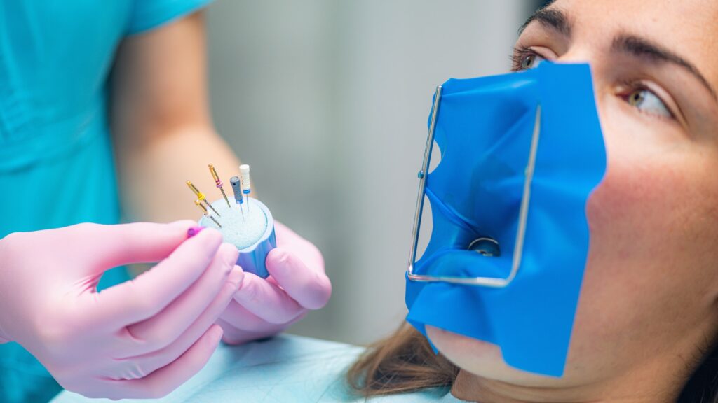 An Endodontist Preparing Barbed Broach for Endodontic Treatment in Dental Clinic.