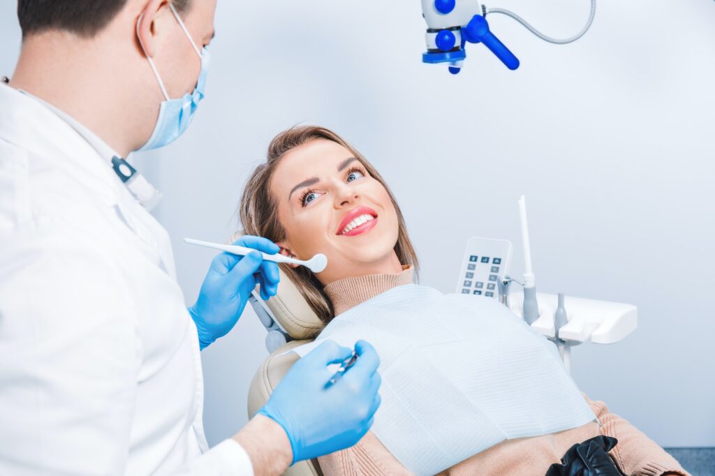 Dental treatment in dental office. Attractive woman with a beautiful smile at dentist appointment.